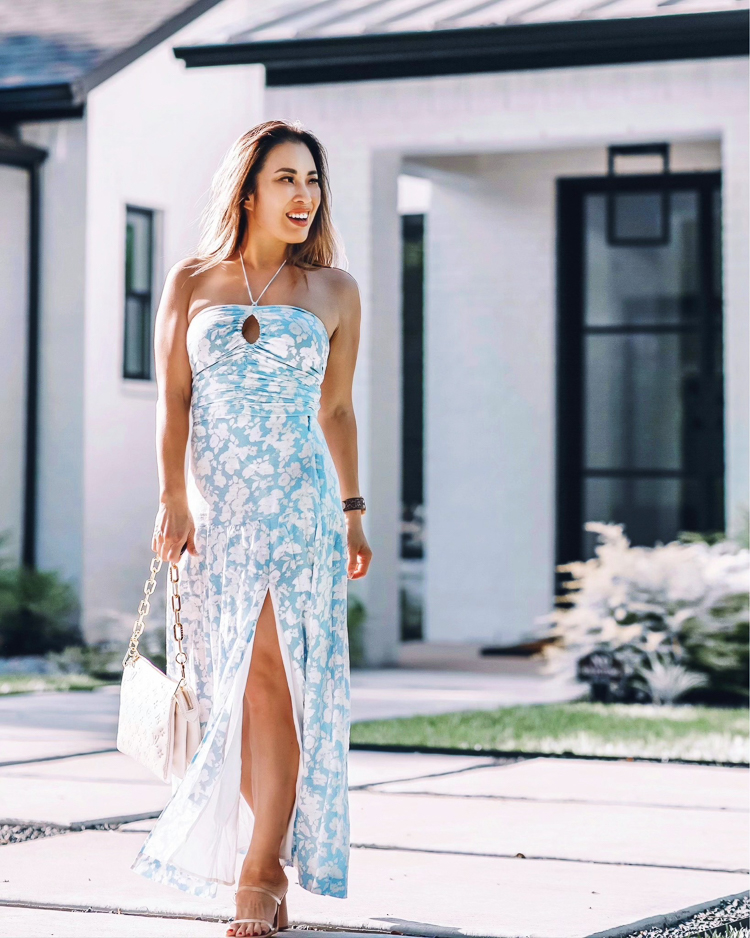 cute & little | dallas petite fashion blog | abercrombie matching set blue floral maxi skirt dress | summer vacation outfit |  Life Update by popular Dallas lifestyle blog, Cute and Little: image of a woman standing outside her home and wearing a blue and white floral print cinched halter top maxi dress and tan strap sandals. 
